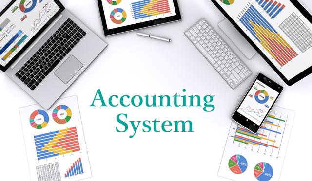 「Accounting System」の文字と会計システムが表示されたPCとプリント