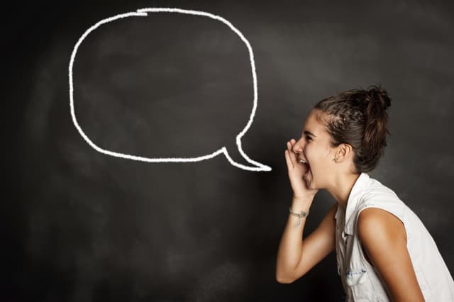 portrait of young girl with speech bubble on chalkboard